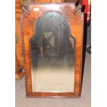 Mahogany wall mirror of arched form with shaped top, the two upper corners carved with acanthus leaf