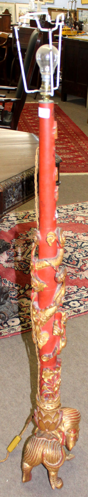 Late 20th century parcel gilded and iron red decorated Oriental standard lamp, the stem carved