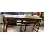 Early 20th century oak stool of rectangular form with planked top over twisted stretchers, 130cm