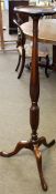 Mahogany torchere stand, circular top and wheatear moulded balustered fluted support terminating