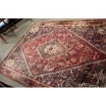 Early/mid-20th century large Caucasian wool rug in mauve, beige and blue with large shaped oval