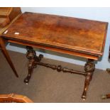 Victorian walnut fold-top card table of rectangular form raised on moulded column supports joined by