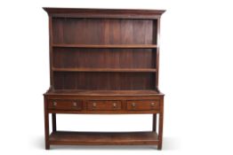 Late Georgian mahogany oak dresser having a two-shelf panelled back, the base section of three