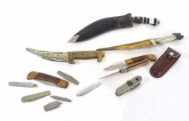 Quantity of 12 knives including Middle Eastern example, various pocket knives and Nepalese Kukri