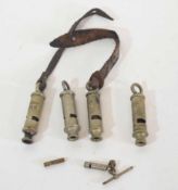 Quantity of four 20th century military whistles, various dates and makers, including 1915 by J