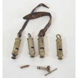 Quantity of four 20th century military whistles, various dates and makers, including 1915 by J