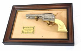 Mounted framed John Wayne Western commemorative .45 single action replica pistol