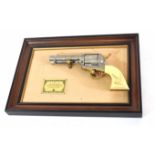 Mounted framed John Wayne Western commemorative .45 single action replica pistol