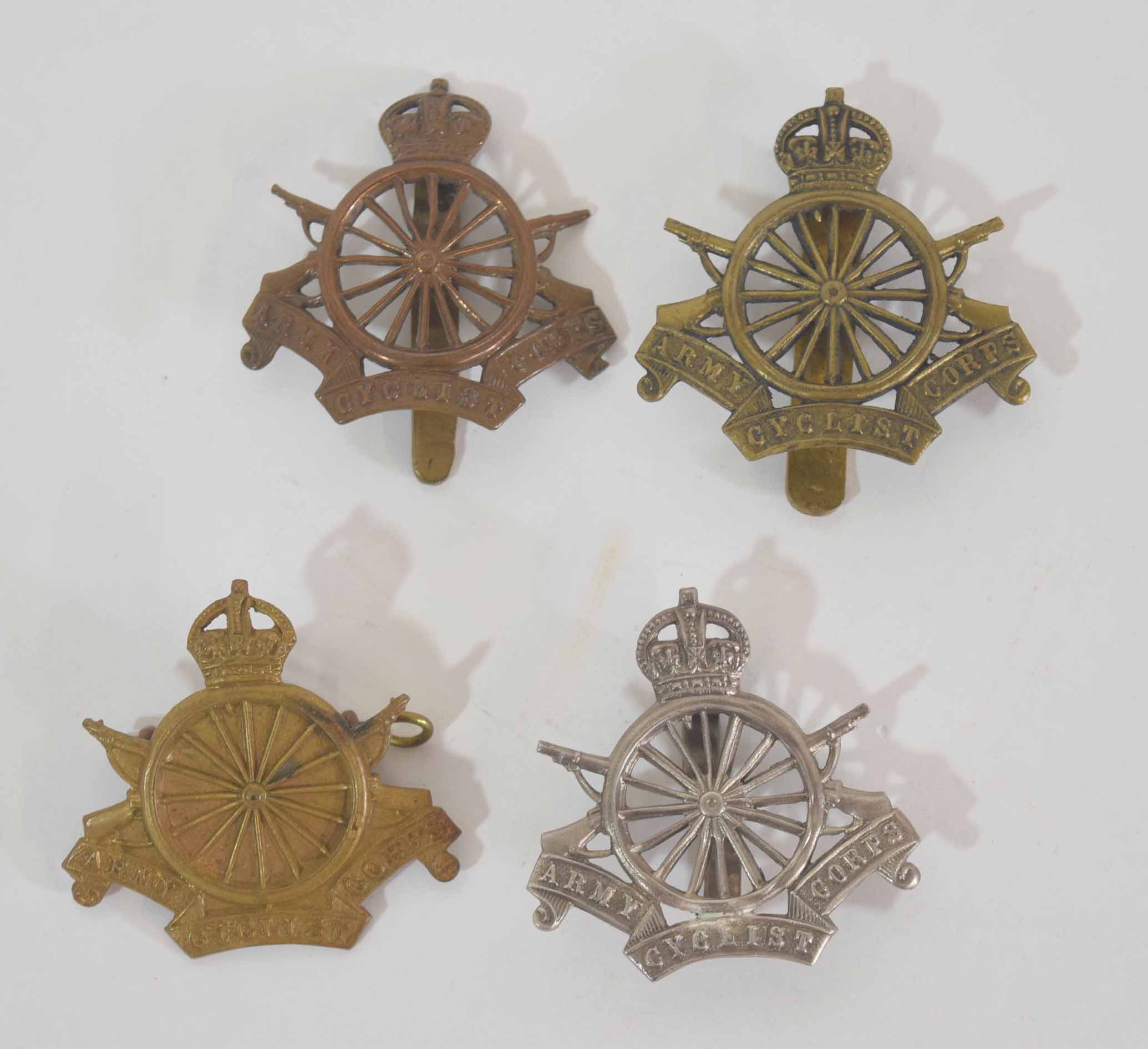 Quantity of four WWI Army Cyclists Corps cap badges to include one officer's silver example, (4)