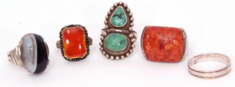 Mixed Lot: four white metal rings, 3 with hardstone designs, one a plain band together with a