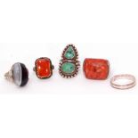 Mixed Lot: four white metal rings, 3 with hardstone designs, one a plain band together with a