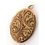 9ct gold double photo locket of oval hinged shape, the front foliate engraved, the verso of plain