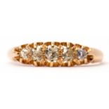 Yellow metal graduated five-stone diamond ring, the 5 old cut diamonds claw set in a carved gallery,