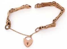 A 9ct gold gate bracelet, the three gate bars joined by plain and textured links to a heart