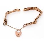 A 9ct gold gate bracelet, the three gate bars joined by plain and textured links to a heart