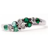 Modern precious metal diamond and emerald ring, alternate entwined design featuring 4 small