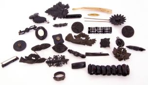 Quantity of various jet and vulcanite brooches, pendant etc to include three metal backed pieces
