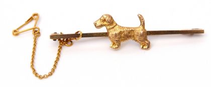 9ct stamped dog bar brooch, the plain polished bar applied with a textured design terrier dog,