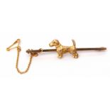 9ct stamped dog bar brooch, the plain polished bar applied with a textured design terrier dog,