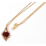 9ct stamped garnet and small diamond pendant suspended from a 9ct chain, gross weight 1.2gms