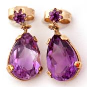 Pair of 9ct gold and amethyst drop earrings, the pear shaped faceted amethyst beneath small amethyst