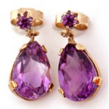 Pair of 9ct gold and amethyst drop earrings, the pear shaped faceted amethyst beneath small amethyst