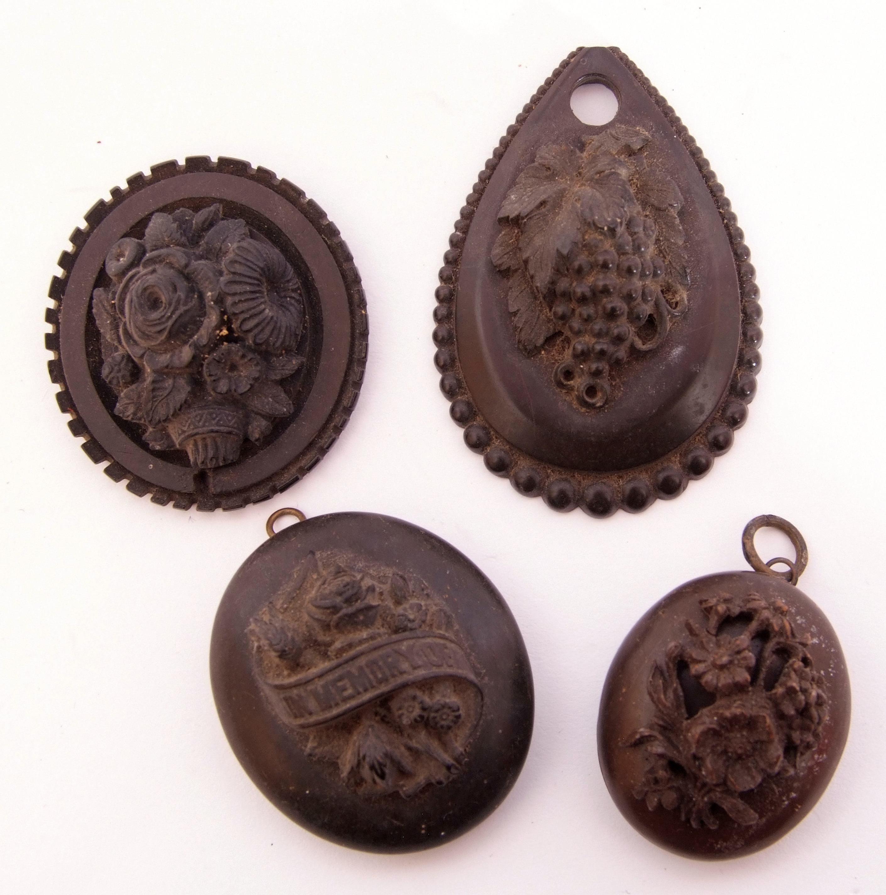 Mixed Lot: large vulcanite In Memoriam locket, a smaller vulcanite oval locket with carved floral