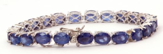 Modern Masaola oval cut sapphire line bracelet, featuring 23 oval treated stones, individually