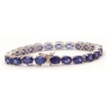 Modern Masaola oval cut sapphire line bracelet, featuring 23 oval treated stones, individually