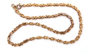 Low grade yellow metal chain, a design with X-shaped links joined by textured oval links, 19cm