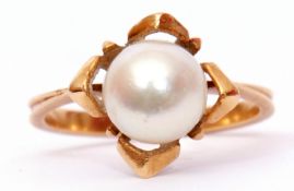 Yellow metal and cultured pearl dress ring, the pearl raised and set between four petals to a