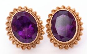 Pair of hallmarked 9ct gold and amethyst earrings, the oval shaped amethysts bezel set and raised in