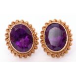 Pair of hallmarked 9ct gold and amethyst earrings, the oval shaped amethysts bezel set and raised in