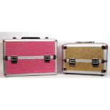 Two make-up/jewellery cases (void), pink leatherette and gold glitter designs