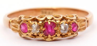 Antique ruby and diamond ring set with 3 graduated rubies and 2 old cut diamonds, all in a carved