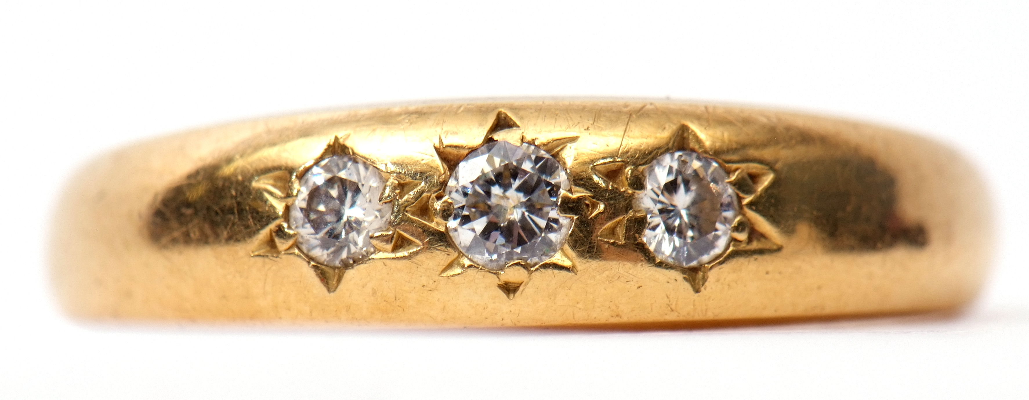 18ct gold and three stone diamond ring, featuring three small graduated brilliant cut diamonds, each