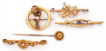 Mixed Lot: 15ct stamped openwork floral brooch, an 18ct stamped seed pearl set floral brooch, a 15ct