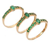 Three modern matching 9ct gold and emerald dress rings, (one stone missing), sizes O-S, gross weight