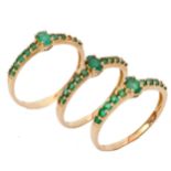 Three modern matching 9ct gold and emerald dress rings, (one stone missing), sizes O-S, gross weight