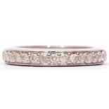 Modern precious metal small diamond full eternity ring, size N/O, gross weight 2.2gms, stamped 375