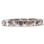 Precious metal 7-stone diamond ring, line set with 7 small diamonds (5 with chips/losses), stamped