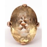 Large Citrine quartz dress ring of oval faceted shape, cardinal set in a plain polished basket