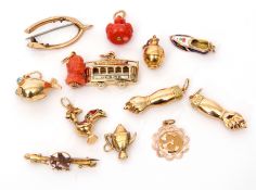 Mixed Lot: two outstretched arm good luck pendants stamped 750, a fish charm stamped 750 (7gms gross