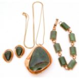 Mixed Lot: A Jade panelled bracelet, a large stylised jade pendant and chain, matching clip-on