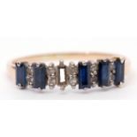 14K stamped sapphire and paste set ring featuring 5 rectangular cut synthetic sapphires (one