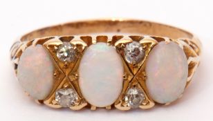 Antique opal and diamond ring, the three oval shaped cabochon opals highlighted with small old cut