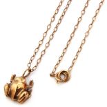 Hallmarked 9ct gold frog pendant suspended from a 9K stamped chain, gross weight 3.2gms