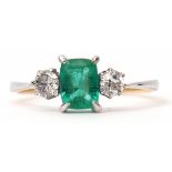 Diamond and emerald three stone ring, rectangular cut emerald flanked by two brilliant cut diamonds,