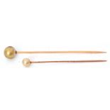 Two yellow metal and simulated pearl stick pins, cased