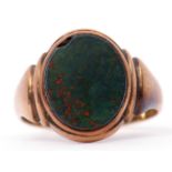 Antique gent's 9ct gold bloodstone set signet ring, the oval shaped panel framed and raised